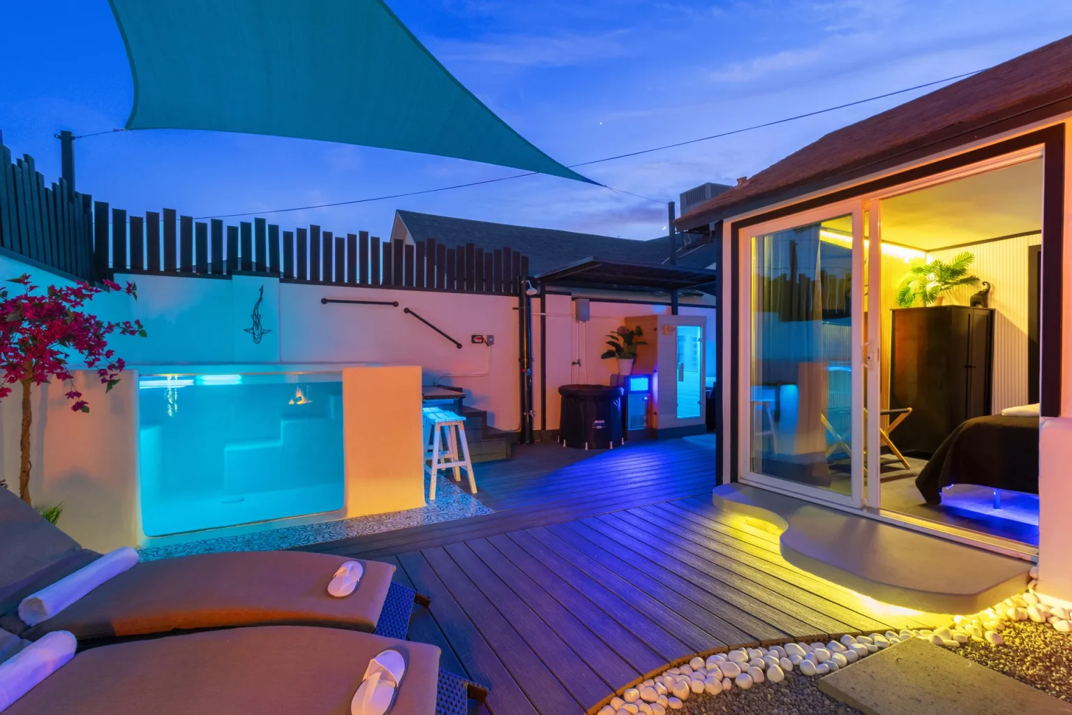 Heated glass pool and private courtyard at twilight